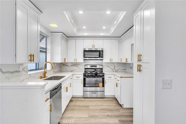 15696 Paine St, Fontana, CA 92336 - kitchen with stainless steel appliances, a sink, light wood-style flooring, white cabinetry, and recessed lighting