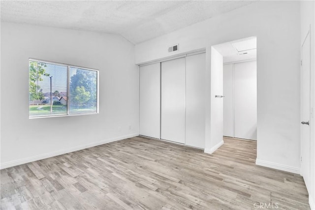 15696 Paine St, Fontana, CA 92336 - unfurnished bedroom with wood finished floors, vaulted ceiling, a textured ceiling, baseboards, and a closet