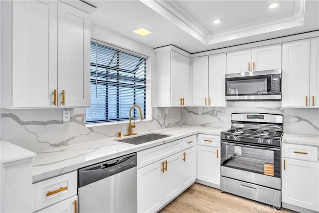 15696 Paine St, Fontana, CA 92336 - kitchen with stainless steel appliances, a sink, a raised ceiling, white cabinetry, and recessed lighting