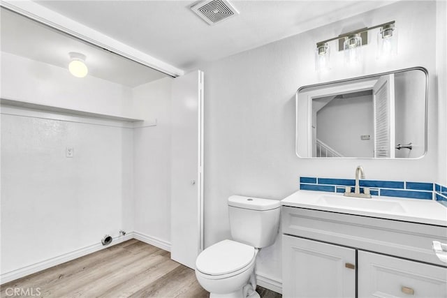15696 Paine St, Fontana, CA 92336 - bathroom featuring wood finished floors, vanity, toilet, and baseboards