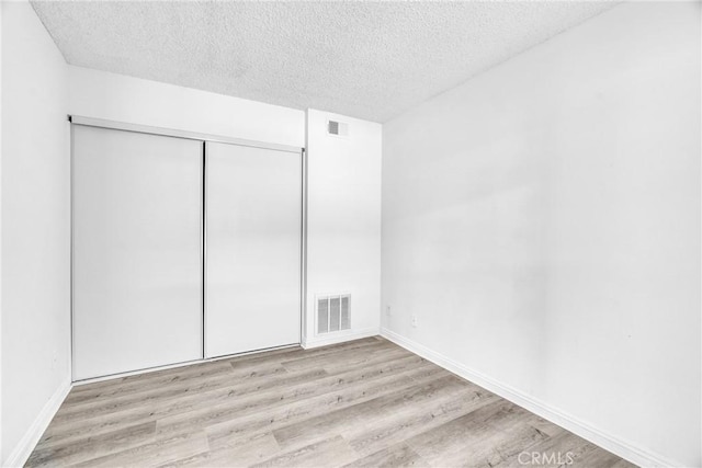 15696 Paine St, Fontana, CA 92336 - unfurnished bedroom with wood finished floors, a textured ceiling, a closet, and baseboards