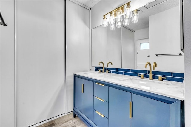 15696 Paine St, Fontana, CA 92336 - full bathroom featuring decorative backsplash, double vanity, and wood finished floors
