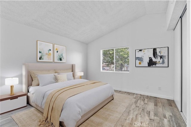 15696 Paine St, Fontana, CA 92336 - bedroom with wood finished floors, vaulted ceiling, a textured ceiling, and baseboards