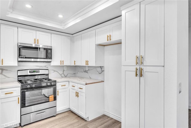 15696 Paine St, Fontana, CA 92336 - kitchen with stainless steel appliances, light wood finished floors, light stone countertops, white cabinetry, and recessed lighting