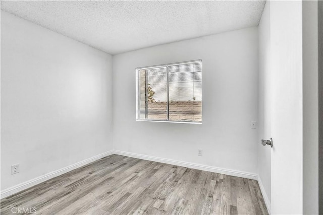 15696 Paine St, Fontana, CA 92336 - spare room featuring wood finished floors, a textured ceiling, and baseboards