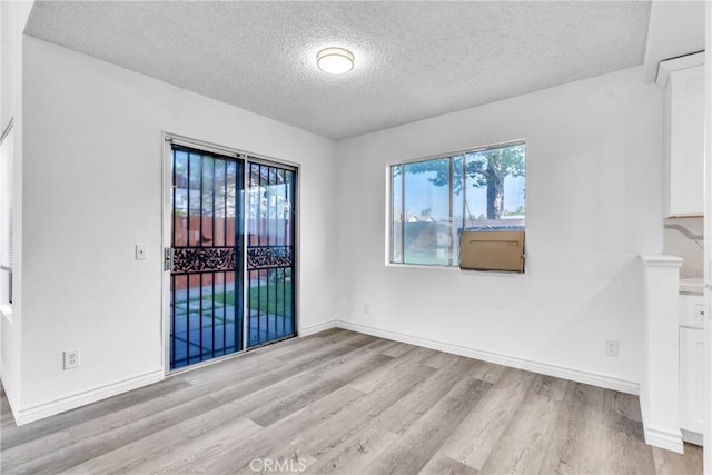 15696 Paine St, Fontana, CA 92336 - spare room with a textured ceiling, light wood-style flooring, and baseboards