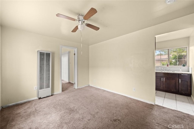 1009 E Peck St, Compton, CA 90221 - unfurnished room featuring a heating unit, light colored carpet, ceiling fan, a sink, and baseboards