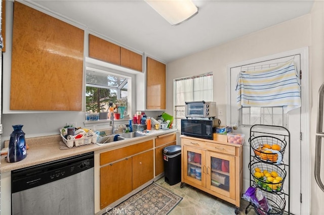1009 E Peck St, Compton, CA 90221 - kitchen featuring dishwasher, black microwave, a sink, light countertops, and brown cabinetry