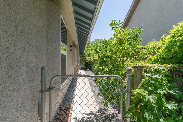 43 Edgewater Ct, Chico, CA 95928 - exterior view of stucco siding and a gate