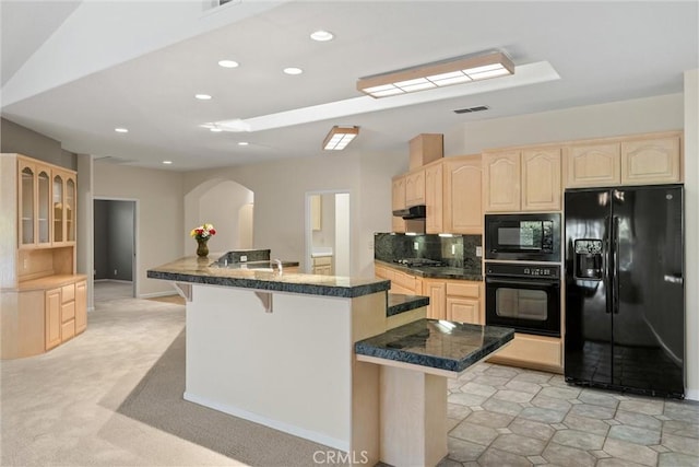 43 Edgewater Ct, Chico, CA 95928 - kitchen with black appliances, light brown cabinets, arched walkways, a breakfast bar, and recessed lighting
