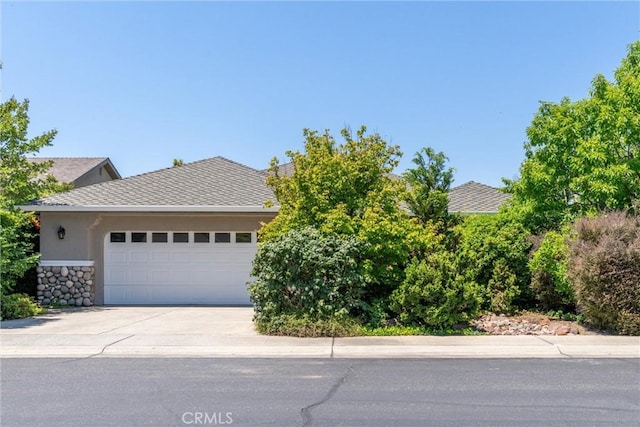 43 Edgewater Ct, Chico, CA 95928 - obstructed view of property featuring an attached garage, concrete driveway, and stucco siding