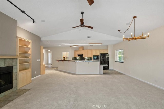 43 Edgewater Ct, Chico, CA 95928 - unfurnished living room with ceiling fan, lofted ceiling, a fireplace, light colored carpet, and arched walkways