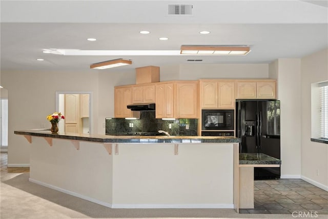 43 Edgewater Ct, Chico, CA 95928 - kitchen with black appliances, under cabinet range hood, light brown cabinetry, a kitchen bar, and recessed lighting