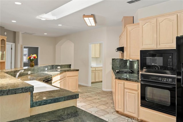 43 Edgewater Ct, Chico, CA 95928 - kitchen with black appliances, light brown cabinets, arched walkways, dark countertops, and tasteful backsplash