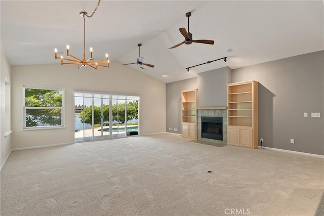 43 Edgewater Ct, Chico, CA 95928 - unfurnished living room featuring a chandelier, a fireplace, light colored carpet, ceiling fan, and a water view