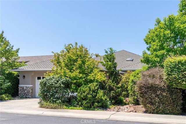 43 Edgewater Ct, Chico, CA 95928 - view of property exterior featuring stucco siding, stone siding, and an attached garage