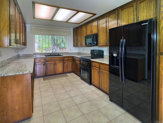 3130 E Victoria Dr, Alpine, CA 91901 - kitchen with black appliances, a sink, light tile patterned flooring, brown cabinetry, and light stone counters