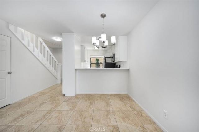 12750 Centralia St Unit 208, Lakewood, CA 90715 - kitchen featuring white cabinetry, a chandelier, decorative light fixtures, and light countertops