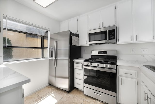 12750 Centralia St Unit 208, Lakewood, CA 90715 - kitchen featuring stainless steel appliances, white cabinetry, light stone counters, and light tile patterned floors