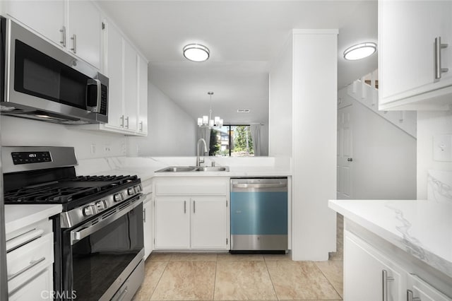 12750 Centralia St Unit 208, Lakewood, CA 90715 - kitchen featuring appliances with stainless steel finishes, a sink, a chandelier, and white cabinets