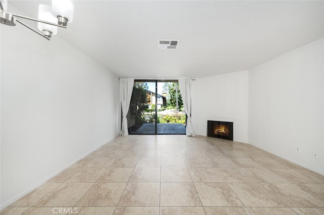 12750 Centralia St Unit 208, Lakewood, CA 90715 - unfurnished living room featuring a warm lit fireplace, tile patterned floors, and expansive windows