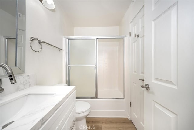 12750 Centralia St Unit 208, Lakewood, CA 90715 - bathroom featuring toilet, wood finished floors, enclosed tub / shower combo, and vanity