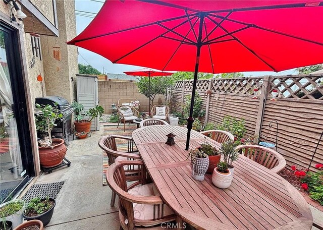 4909 New Castle Ln Unit A, Covina, CA 91724 - fenced backyard featuring outdoor dining area, a patio, and a grill