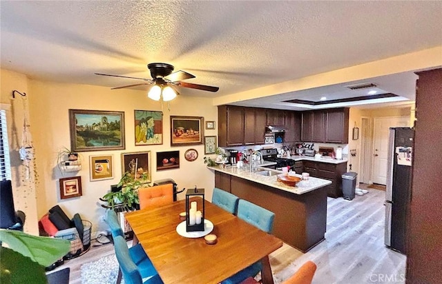 4909 New Castle Ln Unit A, Covina, CA 91724 - dining room with light wood finished floors, a ceiling fan, and a textured ceiling