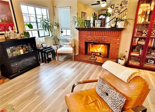 4909 New Castle Ln Unit A, Covina, CA 91724 - sitting room with wood finished floors, a brick fireplace, and ceiling fan