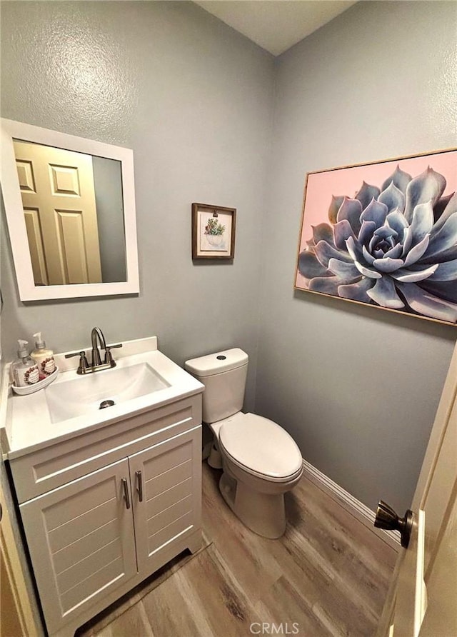 4909 New Castle Ln Unit A, Covina, CA 91724 - bathroom featuring wood finished floors, toilet, vanity, and baseboards