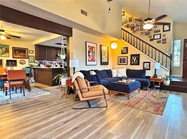 4909 New Castle Ln Unit A, Covina, CA 91724 - living area featuring ceiling fan, light wood-style floors, stairway, and a high ceiling