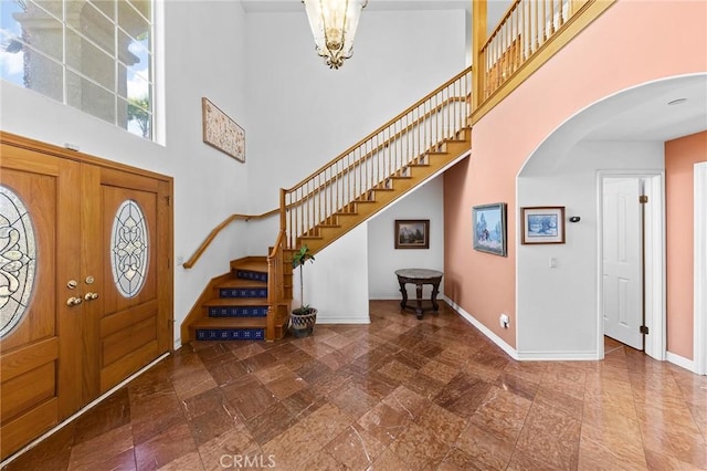 1036 Alpine Ct, Chino Hills, CA 91709 - entryway with a towering ceiling, arched walkways, stairway, and baseboards