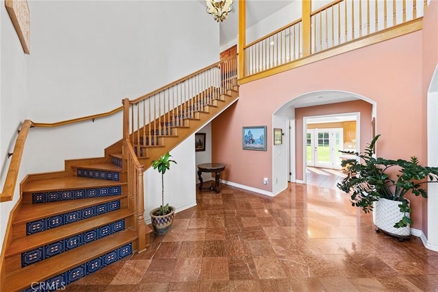 1036 Alpine Ct, Chino Hills, CA 91709 - stairway with arched walkways, a towering ceiling, and baseboards