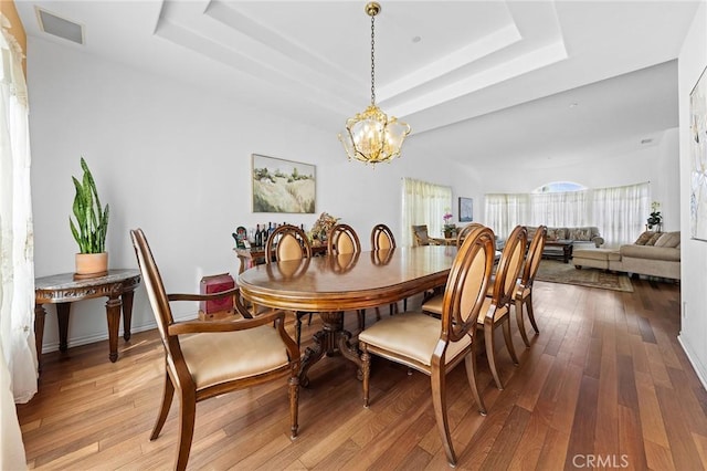 1036 Alpine Ct, Chino Hills, CA 91709 - dining area with a raised ceiling, a chandelier, and hardwood / wood-style floors