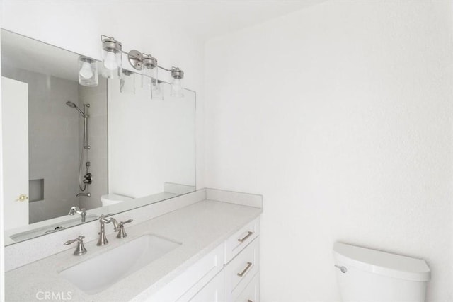 full bathroom featuring toilet, a shower, and vanity