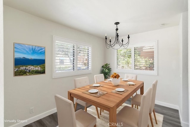 dining space featuring a chandelier, dark wood-style floors, and baseboards