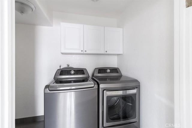 laundry room with cabinet space and independent washer and dryer