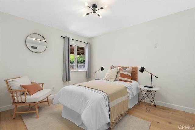 5839 Parkmor Rd, Calabasas, CA 91302 - bedroom with wood finished floors, baseboards, and a chandelier