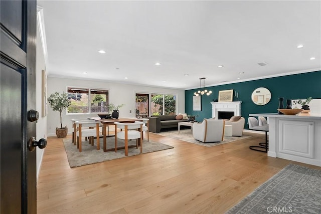 5839 Parkmor Rd, Calabasas, CA 91302 - dining space featuring a fireplace, recessed lighting, ornamental molding, light wood-type flooring, and baseboards