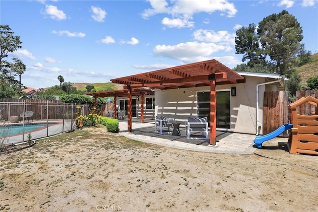 5839 Parkmor Rd, Calabasas, CA 91302 - back of property featuring a pergola, fence, a patio, a playground, and stucco siding