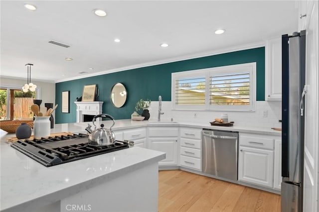 5839 Parkmor Rd, Calabasas, CA 91302 - kitchen featuring stainless steel appliances, a sink, white cabinetry, recessed lighting, and backsplash