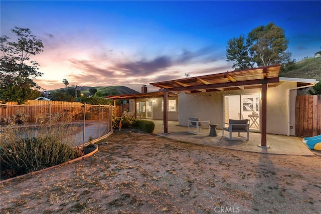 5839 Parkmor Rd, Calabasas, CA 91302 - back of house with a fenced backyard, a patio area, and stucco siding