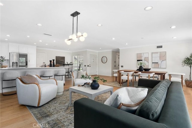 5839 Parkmor Rd, Calabasas, CA 91302 - living room featuring recessed lighting, light wood-style flooring, ornamental molding, a chandelier, and baseboards