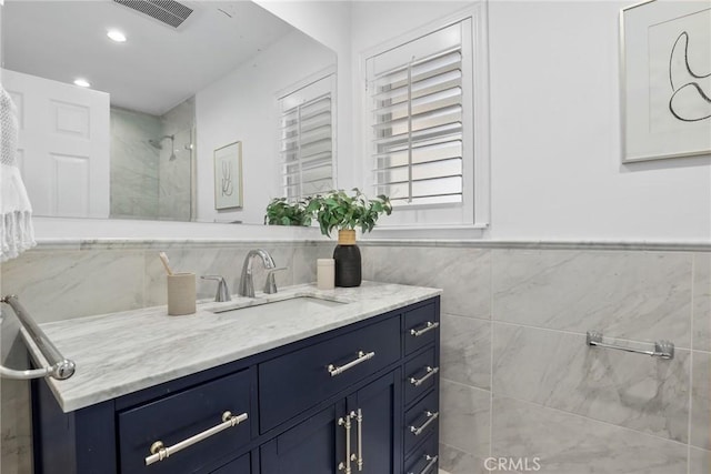 5839 Parkmor Rd, Calabasas, CA 91302 - bathroom featuring tile walls, tiled shower, vanity, wainscoting, and recessed lighting