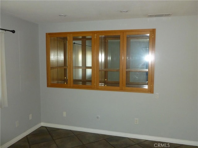 26223 Crestone Dr, Menifee, CA 92586 - spare room featuring dark tile patterned flooring and baseboards