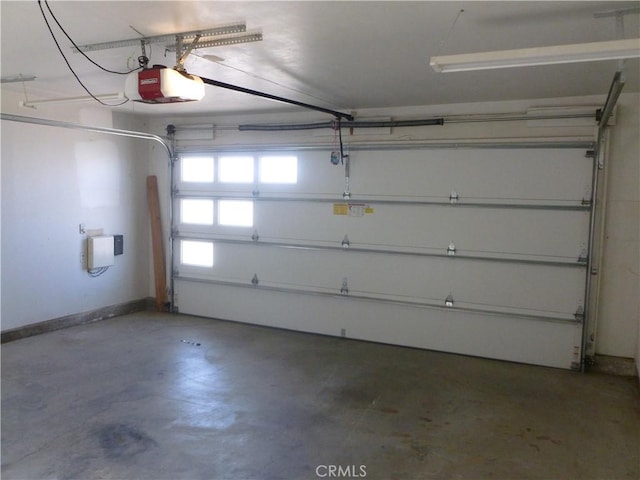 26223 Crestone Dr, Menifee, CA 92586 - garage with a garage door opener and baseboards