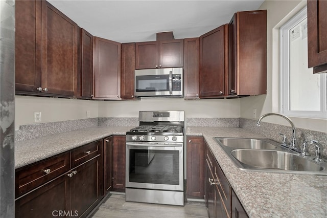 4875 Fairway Blvd, Chino Hills, CA 91709 - kitchen featuring appliances with stainless steel finishes, a sink, light wood-style floors, and light countertops