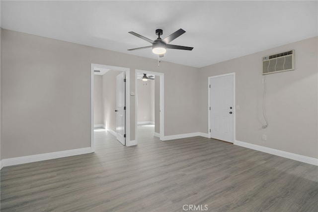 4875 Fairway Blvd, Chino Hills, CA 91709 - spare room featuring a wall mounted air conditioner, ceiling fan, wood finished floors, and baseboards