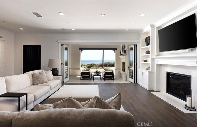 135 Via Artemesia, San Clemente, CA 92672 - living area featuring a high end fireplace, ornamental molding, dark wood finished floors, and recessed lighting
