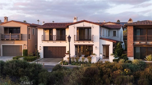 135 Via Artemesia, San Clemente, CA 92672 - rear view of property featuring a balcony, stucco siding, a garage, a tiled roof, and driveway